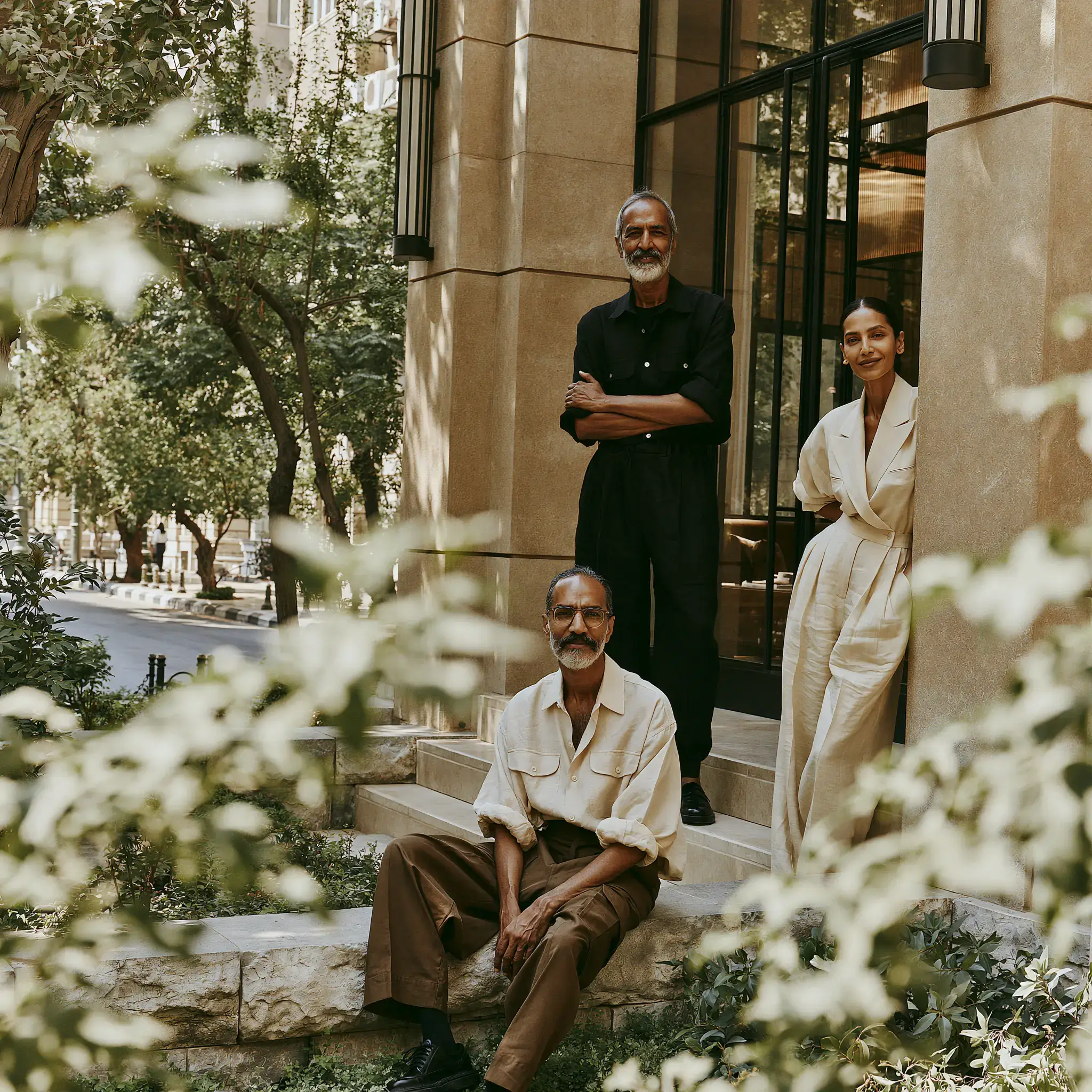 Indian hoteliers sitting in front of the hotel